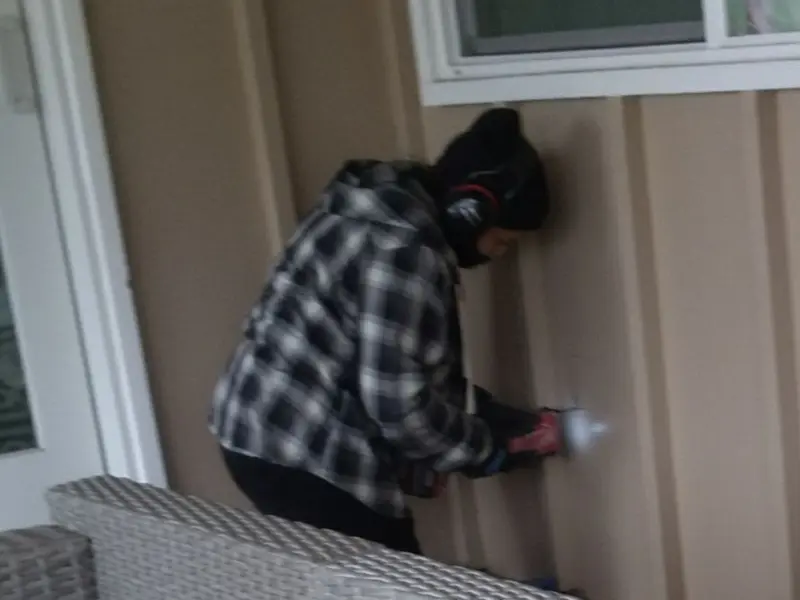 Professional electrician installing an exterior outlet in Jackson